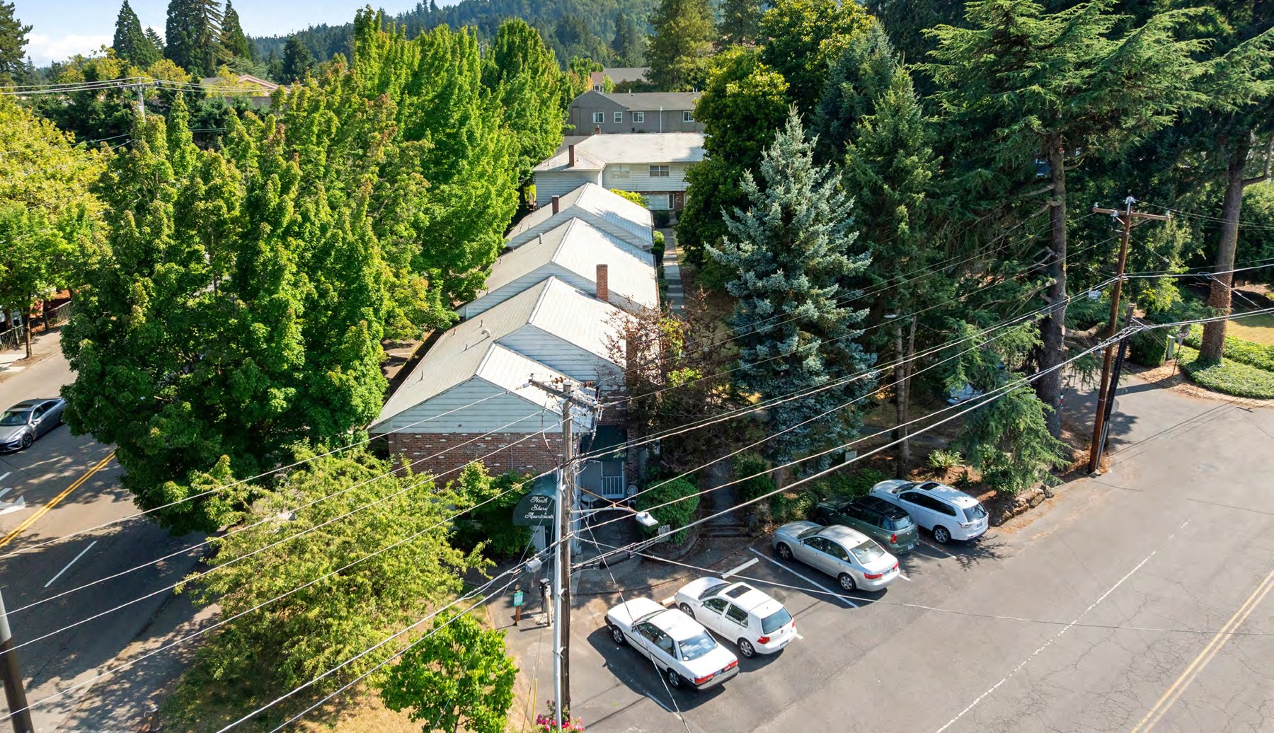Aerial view of the property and surrounding street